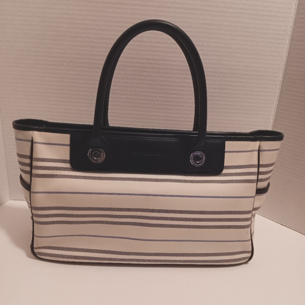 Burberry handbag needs to be cleaned, has spots on the outside,and a spot inside